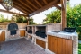 Outdoor barbecue / kitchen includes wood oven